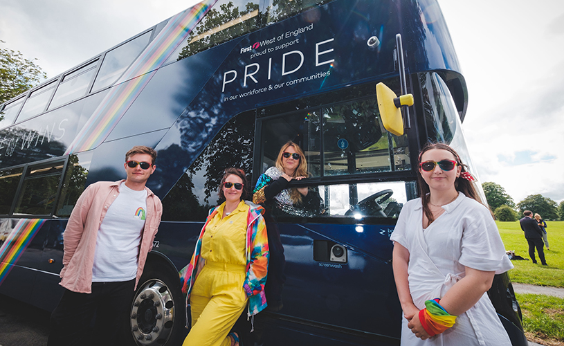 Bristol Pride team in front of rainbow First Bus